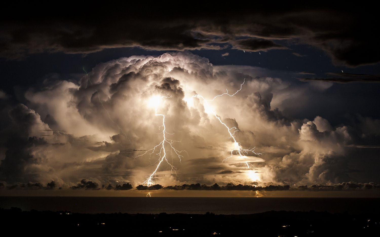Lightning storm over the ocean highlighting the need for a lightning protection system.